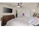 Bright bedroom with ceiling fan, closet and attached bath/toilet room at 8926 Manor Loop # 201, Lakewood Ranch, FL 34202