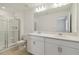 Bathroom showcasing a tiled shower and double vanity with quartz countertop at 9064 Driven Snow St, Sarasota, FL 34241
