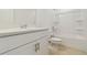 Bathroom featuring a tub with shower and vanity with quartz countertop and storage at 9064 Driven Snow St, Sarasota, FL 34241