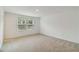 Spacious bedroom featuring carpet, two windows, and neutral paint at 9064 Driven Snow St, Sarasota, FL 34241