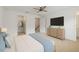 Bedroom featuring TV, walk-in closet, and modern ceiling fan at 9064 Driven Snow St, Sarasota, FL 34241