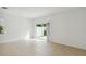 Well-lit bedroom featuring a sliding glass door leading to a private outdoor patio at 9064 Driven Snow St, Sarasota, FL 34241