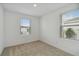 Bright bedroom with neutral carpet and two windows for natural light at 9064 Driven Snow St, Sarasota, FL 34241