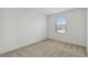 Clean, carpeted bedroom with a window at 9064 Driven Snow St, Sarasota, FL 34241