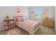 Decorated bedroom with pink accents, floral bedding, and coordinating furniture at 9064 Driven Snow St, Sarasota, FL 34241
