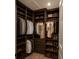 Walk-in closet with custom shelving, hanging rods, and plenty of storage for clothes and shoes at 9064 Driven Snow St, Sarasota, FL 34241