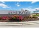 The Townhomes at Skye Ranch community sign with vibrant flowers and manicured landscaping at 9064 Driven Snow St, Sarasota, FL 34241