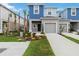 Charming two-story home with a well-manicured lawn and inviting front entrance with a gray garage door at 9064 Driven Snow St, Sarasota, FL 34241