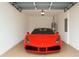 Clean, well-lit garage featuring a sleek red sports car at 9064 Driven Snow St, Sarasota, FL 34241