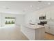 Modern kitchen featuring a large island with sink, quartz countertop, and stainless steel appliances at 9064 Driven Snow St, Sarasota, FL 34241
