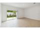 Cozy living room with sliding glass doors to the patio with tile flooring at 9064 Driven Snow St, Sarasota, FL 34241