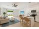 Open-concept living space featuring a modern kitchen, comfortable seating, and a view of the backyard at 9064 Driven Snow St, Sarasota, FL 34241