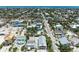 Birds eye view of charming coastal neighborhood with blue ocean backdrop on a sunny day at 104 Magnolia Ave, Anna Maria, FL 34216