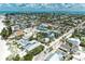 An aerial view showcasing a picturesque coastal community with tropical landscaping near the ocean at 104 Magnolia Ave, Anna Maria, FL 34216