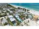 Nice aerial view highlighting a coastal neighborhood featuring homes with pools near the beachfront at 104 Magnolia Ave, Anna Maria, FL 34216