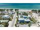 Beautiful aerial view showcasing beachfront homes in a lovely coastal neighborhood near the ocean at 104 Magnolia Ave, Anna Maria, FL 34216