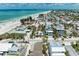 Breathtaking aerial view of coastal neighborhood and homes next to a beautiful, sandy beach at 104 Magnolia Ave, Anna Maria, FL 34216
