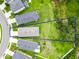 Aerial view of a property with a large backyard, surrounded by well-manicured lawns and lush trees at 10962 High Noon Trl, Parrish, FL 34219