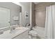 Bright bathroom featuring a single vanity, framed mirror, tub/shower, and modern fixtures at 10962 High Noon Trl, Parrish, FL 34219