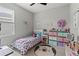 Charming bedroom with a bed, colorful decor, a ceiling fan and a playful bear rug at 10962 High Noon Trl, Parrish, FL 34219