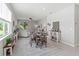 Open dining room with a neutral color palette, seamlessly flowing into the living area at 10962 High Noon Trl, Parrish, FL 34219