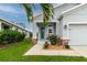 Charming home with a teal door, well-manicured lawn and tidy landscaping at 10962 High Noon Trl, Parrish, FL 34219