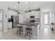 Open kitchen features a granite island, stainless appliances, and ample counter space at 10962 High Noon Trl, Parrish, FL 34219
