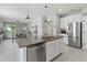 Spacious kitchen with granite island, stainless appliances, and an open layout at 10962 High Noon Trl, Parrish, FL 34219