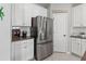 Modern kitchen features stainless steel refrigerator, granite countertops, and plenty of storage at 10962 High Noon Trl, Parrish, FL 34219