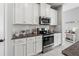 Kitchen boasts stainless appliances, granite countertops, and ample cabinet space at 10962 High Noon Trl, Parrish, FL 34219