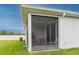 A cozy screened lanai with neutral paint, a table and chairs, and a view of the backyard at 10962 High Noon Trl, Parrish, FL 34219