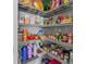 Organized walk-in pantry with wire shelving, packed with snacks, canned goods, drinks and other items at 10962 High Noon Trl, Parrish, FL 34219
