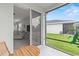 Screened patio with a wood table, an outdoor view, and a glimpse into the house's living room at 10962 High Noon Trl, Parrish, FL 34219