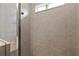 Modern shower with a glass door and tiled walls with a window to allow for natural lighting at 10962 High Noon Trl, Parrish, FL 34219