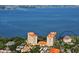 Stunning aerial view of two high-rise buildings with red tile roofs with the bay in the background at 1100 Imperial Dr # 507, Sarasota, FL 34236