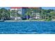 Exterior waterfront view of a multi-story building with lush landscaping and waterfront views at 1100 Imperial Dr # 507, Sarasota, FL 34236