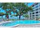 A tranquil pool area surrounded by lush landscaping and bay views, perfect for relaxation at 1100 Imperial Dr # 507, Sarasota, FL 34236