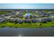 Aerial view of neighborhood with home in focus next to pond and lush green landscaping at 12712 Dusty Trail Dr, Sarasota, FL 34238