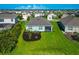 Aerial view of the home's backyard, showcasing lush green grass and landscaping at 12712 Dusty Trail Dr, Sarasota, FL 34238