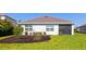 Well-maintained backyard featuring healthy green grass and dark mulch landscaping at 12712 Dusty Trail Dr, Sarasota, FL 34238