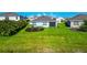 Aerial view of the home's backyard, showcasing lush green grass and landscaping at 12712 Dusty Trail Dr, Sarasota, FL 34238