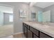 Bathroom featuring a double sink vanity with dark cabinets and a large mirror at 12712 Dusty Trail Dr, Sarasota, FL 34238