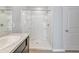Bathroom featuring a shower with white shower surround, sink and dark vanity at 12712 Dusty Trail Dr, Sarasota, FL 34238