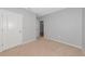 Bedroom with neutral walls and carpet, with white baseboards and white closet door at 12712 Dusty Trail Dr, Sarasota, FL 34238