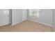 Neutrally painted bedroom with base trim, beige carpeting, and a window with blinds at 12712 Dusty Trail Dr, Sarasota, FL 34238