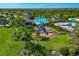 Aerial view of a community featuring swimming pool, playgrounds, a clubhouse, and lush landscaping at 12712 Dusty Trail Dr, Sarasota, FL 34238