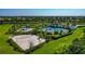 Aerial shot of the community pool with playground, beach volleyball court, and clubhouse at 12712 Dusty Trail Dr, Sarasota, FL 34238