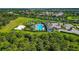 Aerial shot of the community pool with playground, beach volleyball court, and clubhouse at 12712 Dusty Trail Dr, Sarasota, FL 34238