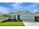Charming single-story home featuring a well-manicured lawn and attached two-car garage at 12712 Dusty Trail Dr, Sarasota, FL 34238