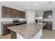 Modern kitchen features stainless steel appliances, granite countertops, and dark wood cabinets at 12712 Dusty Trail Dr, Sarasota, FL 34238